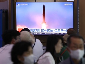People watch a television broadcast showing a file image of a North Korean missile launch at the Seoul Railway Station on June 5, 2022 in Seoul, South Korea.