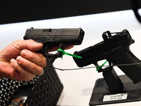 An attendee holds a Glock Ges.m.b.H. pistol during the National Rifle Association (NRA) Annual Meeting at the George R. Brown Convention Center, in Houston, Texas on May 28, 2022.