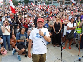 James Topp, a Canadian Forces veteran who marched across Canada protesting against the COVID-19 mandates, speaks to supporters as he arrives at the Tomb of the Unknown Soldier and the National War Memorial ahead of Canada Day in Ottawa, June 30, 2022.