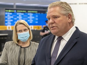 Ontario Premier Doug Ford and Solicitor General Sylvia Jones answer questions after touring the COVID-19 testing centre in Terminal 3 at Pearson Airport in Toronto on Wednesday, February 3, 2021. THE CANADIAN PRESS/Frank Gunn
