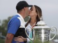 Brooks Koepka, left, kisses his girlfriend Jena Sims after winning the PGA Championship golf tournament, Sunday, May 19, 2019, at Bethpage Black in Farmingdale, N.Y.