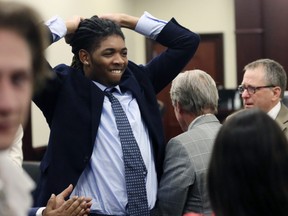 Isimemen Etute celebrates at the end of his trial in Montgomery County Circuit Court Friday, May 27, 2022 in Christiansburg Va.