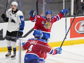 Edmonton Oil Kings' Jaxsen Wiebe, right, celebrates his game-winning goal with teammate Kaiden Guhle in front of Saint John Sea Dogs' Vincent Sevigny during overtime of Memorial Cup hockey action in Saint John, N.B. on Wednesday, June 22, 2022.