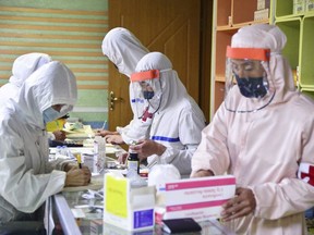 Members of the North Korean army supply medicines to residents at a pharmacy, amid growing fears over the spread of COVID-19, in Pyongyang, North Korea, in this photo released by Kyodo on May 18, 2022.