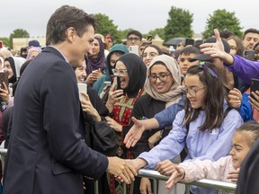 Prime Minister Justin Trudeau greets some of the more than 2,000 people who gathered in northwest London to march in honour of the first anniversary of the alleged hate-motivated killing of the Afzaal family. Photograph taken on Sunday June 5, 2022. Mike Hensen/The London Free Press