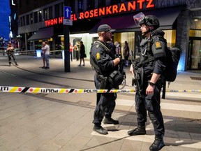 Police secure the area after a shooting in Oslo, Norway, early Saturday, June 25, 2022.