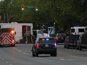 Police officers including a explosive Disposal Unit called in from Vancouver attend the scene of a gunfire incident involving multiple people and injuries in Saanich, near Victoria, on Tuesday.