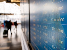 A flight schedule board is seen at Ronald Reagan Washington National Airport (DCA) in Arlington, Virginia, on January 15, 2022.