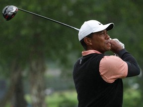 May 21, 2022; Tulsa, OK, USA; Tiger Woods plays his shot from the ninth tee as rain falls during the third round of the PGA Championship golf tournament at Southern Hills Country Club.