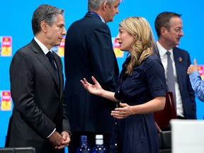 U.S. Secretary of State Antony Blinken speaks with Canadian Foreign Minister Melanie Joly during a round table meeting at the NATO summit in Madrid, June 29, 2022.