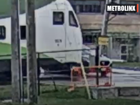 A screengrab from video released by Metrolinx of a car about to be hit by a GO Transit train after skirting the barrier.