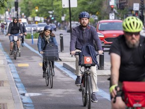 Cyclists make their way down the REV — Reseau Express Vélo —on St-Denis St. during the morning commute in Montreal on June 2, 2022.