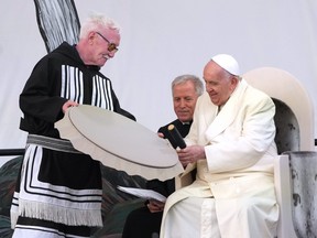Pope Francis receives a traditional drum as a gift during a public event in Iqaluit, Nunavut on Friday, July 29, 2022, during his papal visit across Canada.