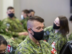 Canadian Armed Forces members wait to load unto a C-150 Polaris,to join the CAF troops already deployed in support of NATO in Eastern and Central Europe under Operation REASSURANCE on Friday, April 15, 2022 in Edmonton.