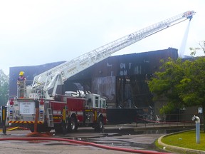 Clarington Fire Service douse hotspots on the Durham Region Police property warehouse on Courtice Court on Monday, July 18, 2022. A fire erupted inside the warehouse Sunday night around 6 p.m.