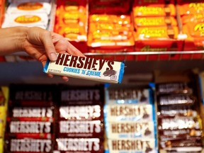 An employee shows a Hershey's chocolate bar made in the U.S., in Berlin, Germany, Aug. 13, 2018.