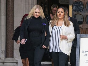 The mother of Archie Battersbee, Hollie Dance, left, leaves the Royal Courts of Justice in London, England, Monday, July 25, 2022.