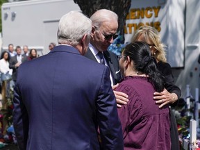 U.S. President Joe Biden and first lady Jill Biden talk with principal Mandy Gutierrez and superintendent Hal Harrell as they visit Robb Elementary School to pay their respects to the victims of the mass shooting in Uvalde, Texas, May 29, 2022.