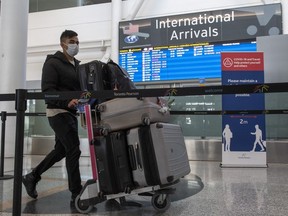 A passenger arrives from New Delhi at Pearson Airport in Toronto on April 21, 2021. Infectious disease experts are at odds over the value of testing random travellers into the country for COVID-19 as the federal government relaunched its airport test program Tuesday.