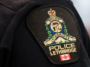 A close up of a police logo in Lethbridge, Alta., on Wednesday, March 10, 2021. Police in Lethbridge say a woman has been charged with attempted murder after a worker in a law office was taken hostage and stabbed multiple times in the neck.THE CANADIAN PRESS/David Rossiter