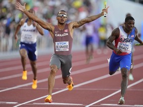 Andre De Grasse, of Canada, wins the final in the men's 4x100-meter relay at the World Athletics Championships on Saturday, July 23, 2022, in Eugene, Ore.&ampnbsp;Sprinter Andre De Grasse and decathlete Pierce LePage are among the top Canadian&ampnbsp; track and field stars who have withdrawn from competing at the upcoming Commonwealth Games.