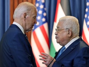 This handout picture provided by the Palestinian Authority's press office (PPO) shows U.S. President Joe Biden, left, and Palestinian president Mahmud Abbas speaking together after their statements to the media at the Muqataa Presidential Compound in the city of Bethlehem in the occupied West Bank on July 15, 2022.