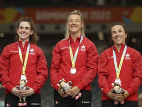 Canada's (left to right) Sarah Orban, Kelsey Mitchell and Lauriane Genest celebrate with silver medals during a medal ceremony for the Women's Team Sprint at the Commonwealth Games track cycling at Lee Valley VeloPark in London, Friday, July 29, 2022.