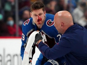 Colorado Avalanche centre Nathan MacKinnon is treated for an injury in the first period against the Boston Bruins at Ball Arena in January 2022.