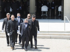 Pallbearers carry the caskets of Karolina Ciasullo and her three young daughters, six year-old Klara Ciasullo, four year-old Lilianna Ciasullo and one year-old Mila Ciasullo, who were killed in a fatal vehicle crash in Brampton, leave the funeral service in Brampton, Ont., on Thursday, June 25, 2020.