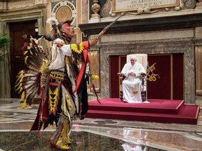 A member of Canada's Indigenous delegation chants and dances before Pope Francis during an audience at the Vatican on Friday, April 1, 2022
