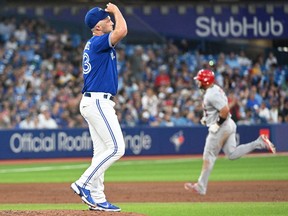 Toronto Blue Jays relief pitcher Trevor Richards prepares for his next pitch as St. Louis Cardinals first baseman Albert Pujols rounds the bases after hitting a three run home run in the fifth inning at Rogers Centre in Toronto, July 27, 2022.