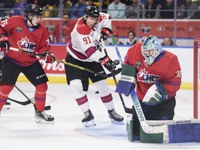 Team White's Nathan Gaucher of the Quebec Remparts tries to tip the puck past Team Red goalie Reid Dyck of the Swift Current Broncos during the 2022 Kubota CHL/NHL Top Prospects game in Kitchener, Ontario on Wednesday, March 23, 2022.