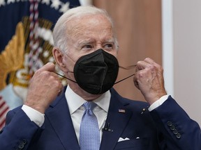 President Joe Biden removes his face mask as he arrives to speak about the economy during a meeting with CEOs in the South Court Auditorium on the White House complex in Washington, Thursday, July 28, 2022.