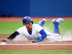 George Springer of the Toronto Blue Jays scores a run on a RBI single by Alejandro Kirk in the third inning against the Detroit Tigers at Rogers Centre on July 28, 2022 in Toronto, Ontario, Canada.