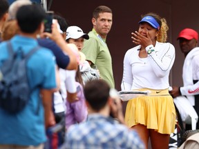 Naomi Osaka of Japan wipes a tear while giving a fan her racket after she retired early from her match against Kaia Kanepi of Estonia during the National Bank Open, part of the Hologic WTA Tour, at Sobeys Stadium on August 9, 2022 in Toronto.