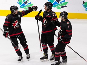 Team Canada's Mason McTavish (23) celebrates a goal with teammates on Team Finland's goaltender Leevi Merilainen (1) during second period IIHF 2022 World Junior Championship play at Rogers Place in Edmonton, on Monday, Aug. 15, 2022. Photo by Ian Kucerak