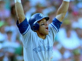 Local Input~ OAKLAND, : Toronto Blue Jays Roberto Alomar raises his arms as he watches the ball he just hit off of Oakland A's Dennis Eckersley sail over the right field wall 11 October, 1992 in the ninth inning to tie the game at 6-6 in game four of the American League Championship Series in Oakland, CA. The home run was Alomar's fourth hit of the game.