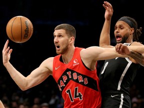 Toronto Raptors guard Svi Mykhailiuk (14) loses the ball as he drives to the basket against Brooklyn Nets guard Patty Mills (8) during the first quarter at Barclays Center.