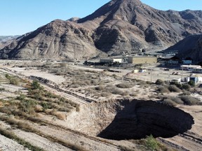 A sinkhole that was exposed last week has doubled in size, at a mining zone close to Tierra Amarilla town, in Copiapo, Chile, Aug. 7, 2022.