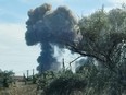 Smoke rises after explosions were heard from the direction of a Russian military airbase near Novofedorivka, Crimea, Tuesday, Aug. 9, 2022.