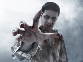 Scary zombie hand reaching out.