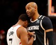 Vince Carter #15 of the Atlanta Hawks and Kyle Lowry #7 of the Toronto Raptors hug after the Raptors 122-117 win at State Farm Arena on January 20, 2020 in Atlanta, Georgia.