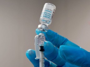 Miriala Gonzalez, a registered nurse, measures out a monkeypox vaccine shot at a vaccination site setup in Tropical Park by Miami-Dade County and Nomi Health on Aug. 15, 2022 in Miami, Fla.