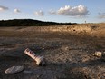 A bouy normally used to mark "No wake" zones sits on dry land at Medina Lake outside of San Antonio as the majority of Texas experiences drought amid an extreme heat wave hitting the state, in Medina County, Texas, June 18, 2022.