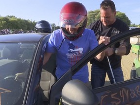 In this image from video provided by WNEM-TV, Michigan Supreme Court Justice Richard Bernstein, who is blind, gets into a car to drive for the first time at the Genesee County fairgrounds in Mt. Morris, Mich., on Tuesday, Aug. 23, 2022.