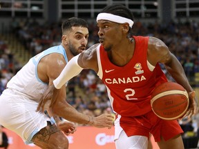 Canada's Shai Gilgeous-Alexander moves around Argentina's Facundo Campazzo during the FIBA Basketball World Cup 2023 Americas Qualifiers in Victoria, B.C., on Thursday, August 25, 2022.