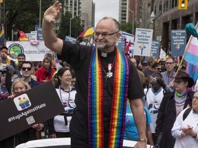Rev. Brent Hawkes, the pastor who officiated Canada's first legally recognized same-sex marriages, rides in a car during Toronto's Pride Parade, June 28, 2015. Russia has sanctioned a raft of Canadian public figures including Major-General Michael Wright, Head of Canadian Forces Intelligence command, and the well-known Toronto pastor.