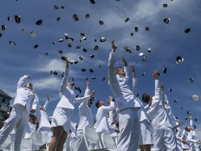 U.S. Coast Guard Academy cadets throw their hats in the air at the conclusion of the 141st Commencement Exercises at the U.S. Coast Guard Academy on Wednesday, May 18, 2022 in New London, Conn.