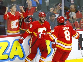 Calgary Flames defenceman Oliver Kylington celebrates a goal with playing partner Chris Tanev last season.
