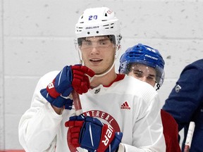 Canadiens' Filip Mesar tries to peak over Juraj Slafkovsky's shoulder at rookie camp on Tuesday, Sept. 20, 2022.